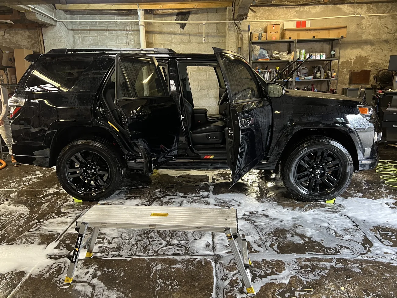 Hands-on wash and detailing preparation of the black Toyota 4Runner